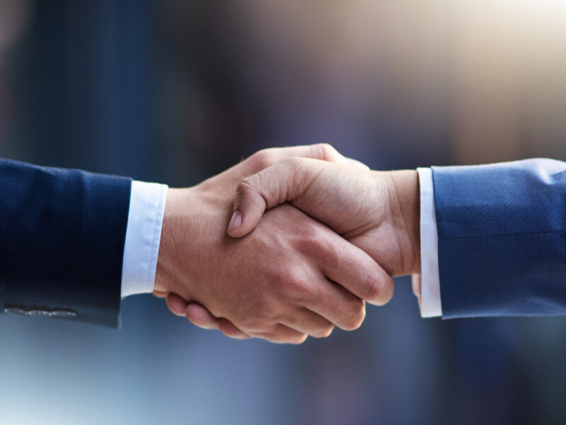 Handshake suggesting partnership between different brands
